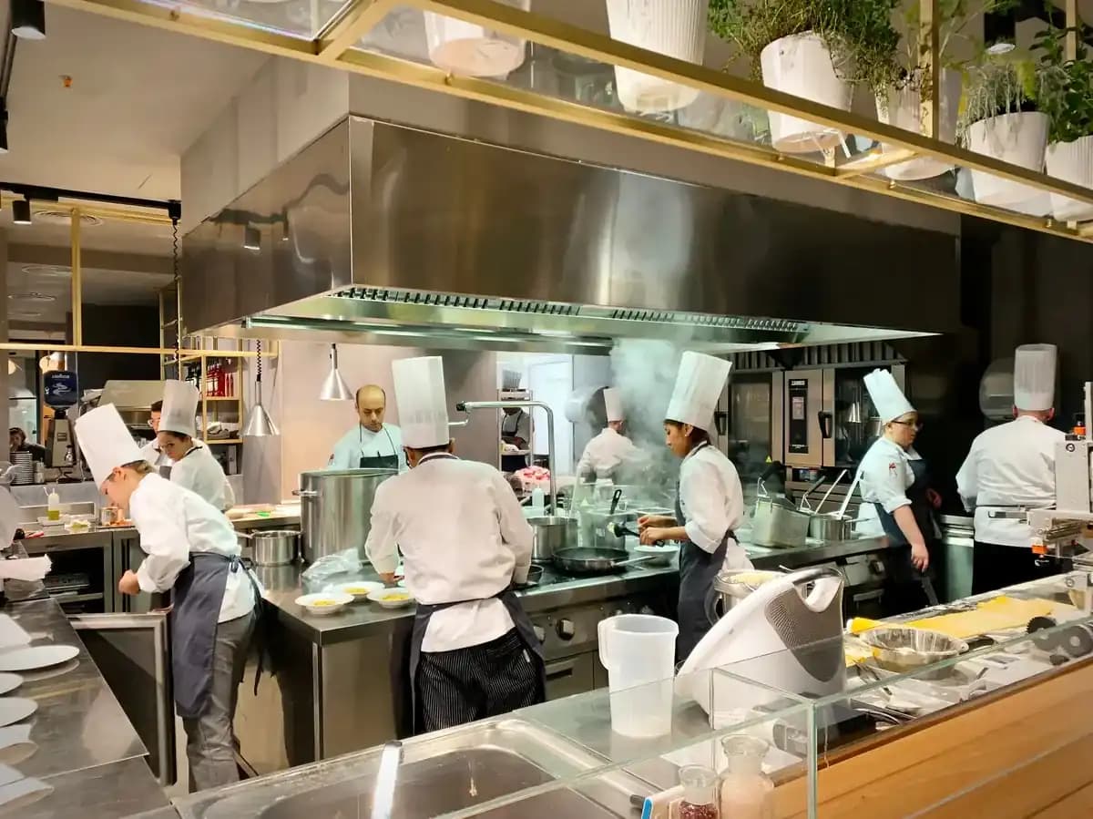 Executive chef leading kitchen team with confidence - culinary leadership coaching